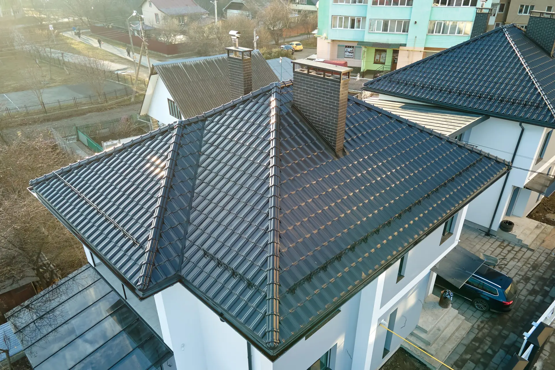 Aerial view of private house with ceramic shingles covered roof top. Investment in real estate concept.