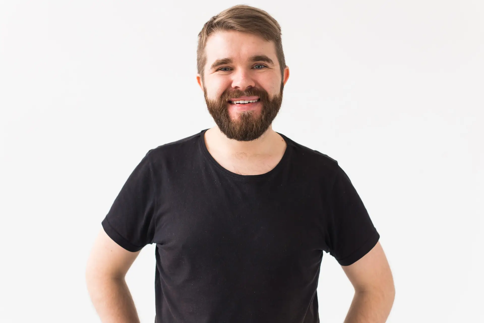 Cheerful guy smiled happily, has excited expression over shiny studio background. Holidays, youth, emotions.